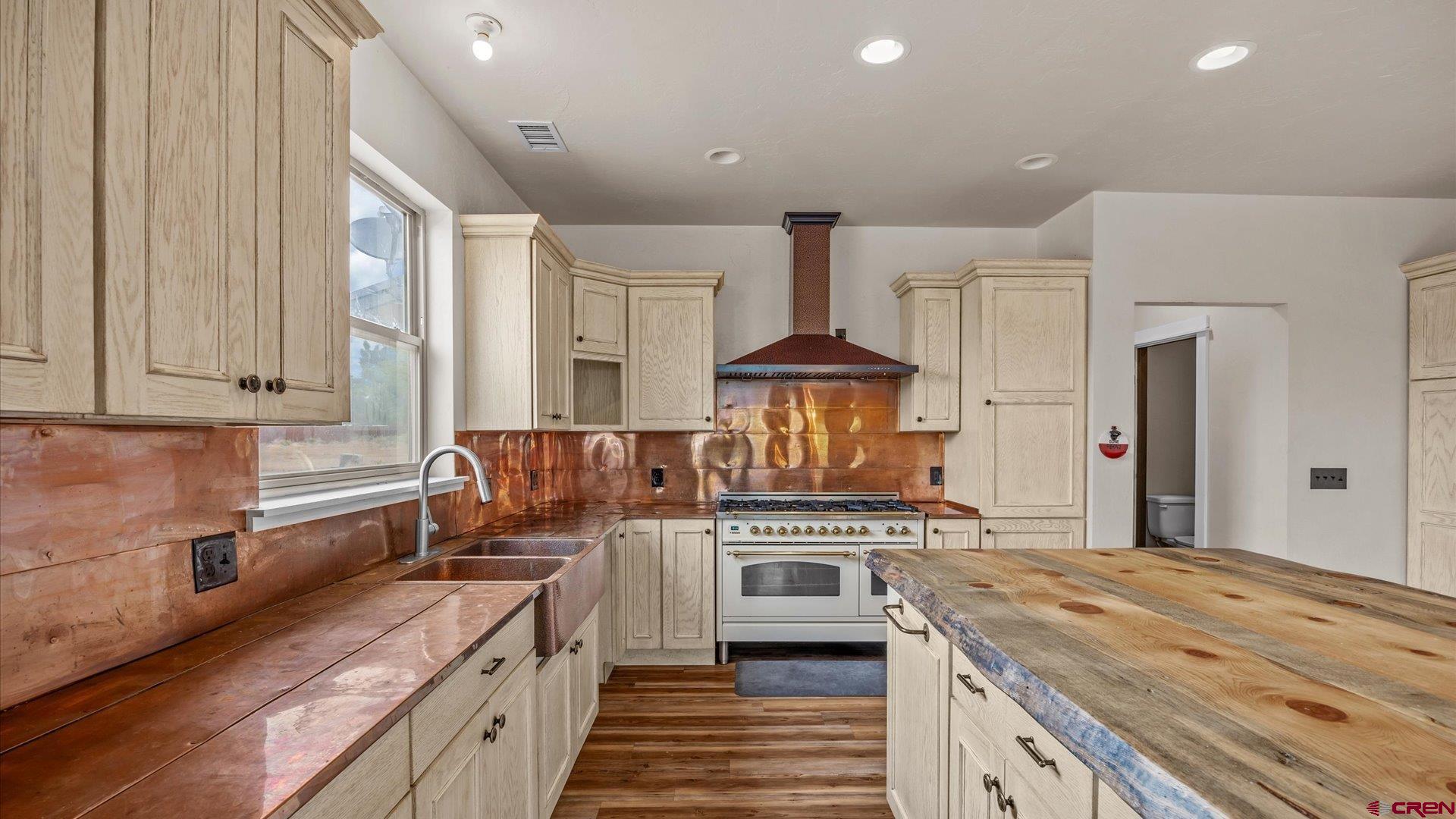 9097 2150th Road Austin, CO 81410 - Photo 6 of 19 a kitchen with a stove and a wooden cabinets