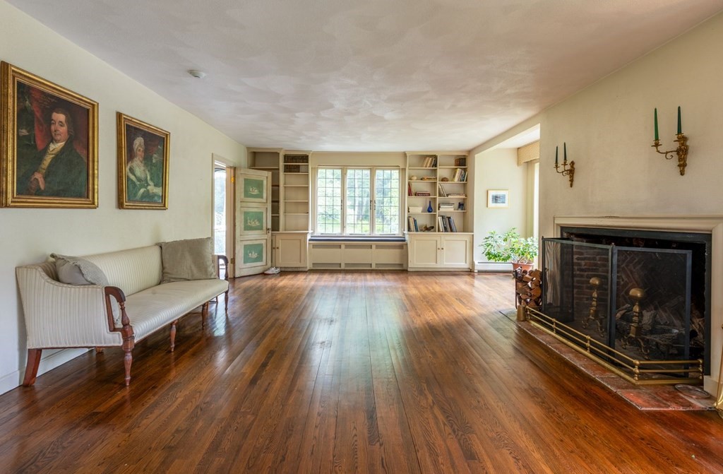 893 Highland Street Hamilton, MA 01982 - Photo 11 of 42 a living room with furniture and a fireplace