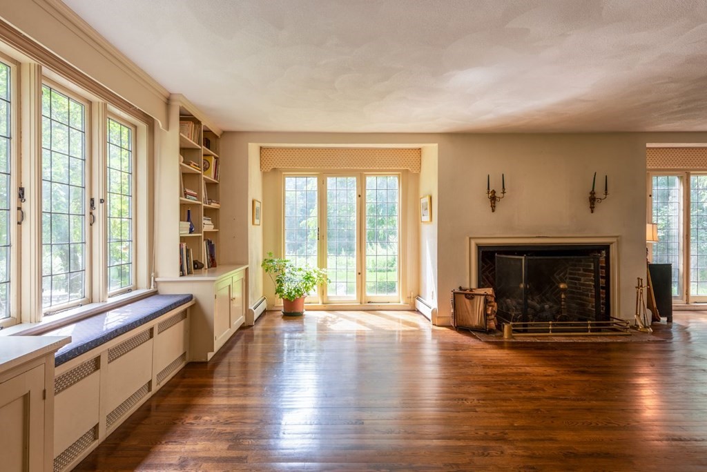 893 Highland Street Hamilton, MA 01982 - Photo 13 of 42 a living room with furniture and a fireplace