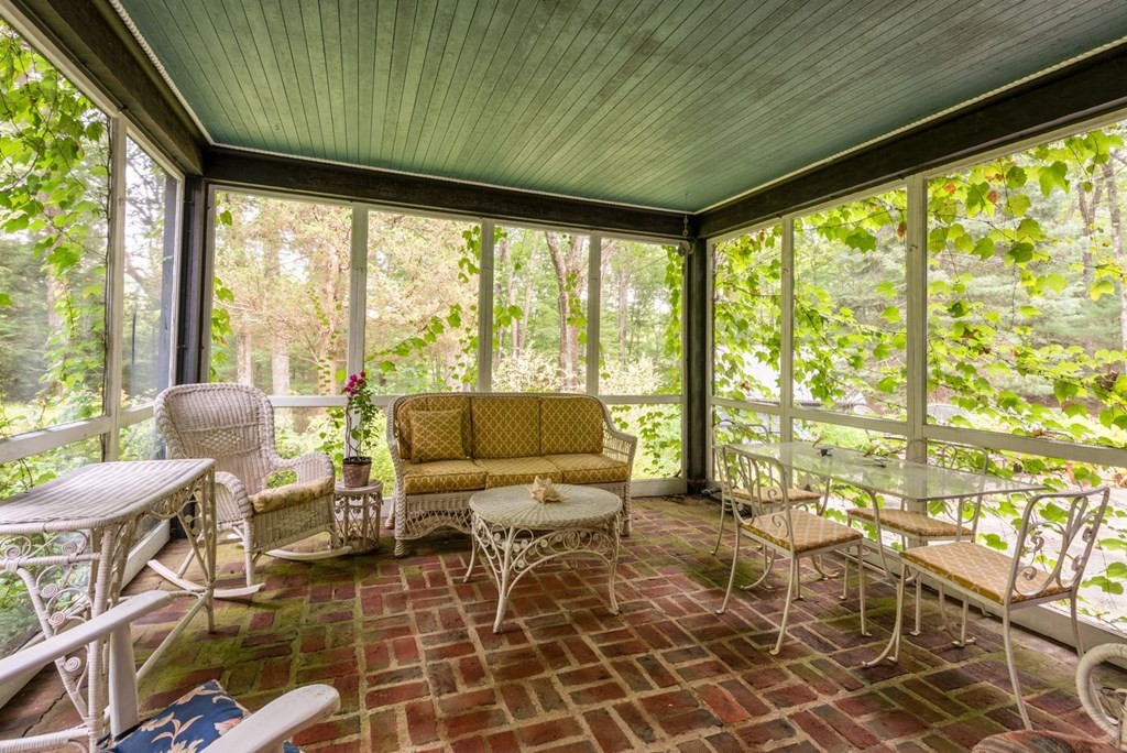 893 Highland Street Hamilton, MA 01982 - Photo 18 of 42 a living room with furniture and a floor to ceiling window