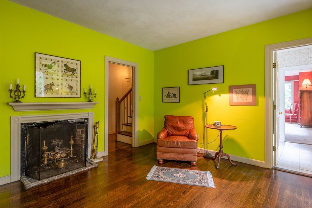 893 Highland Street Hamilton, MA 01982 - Photo 28 of 42 a living room with furniture and a fireplace