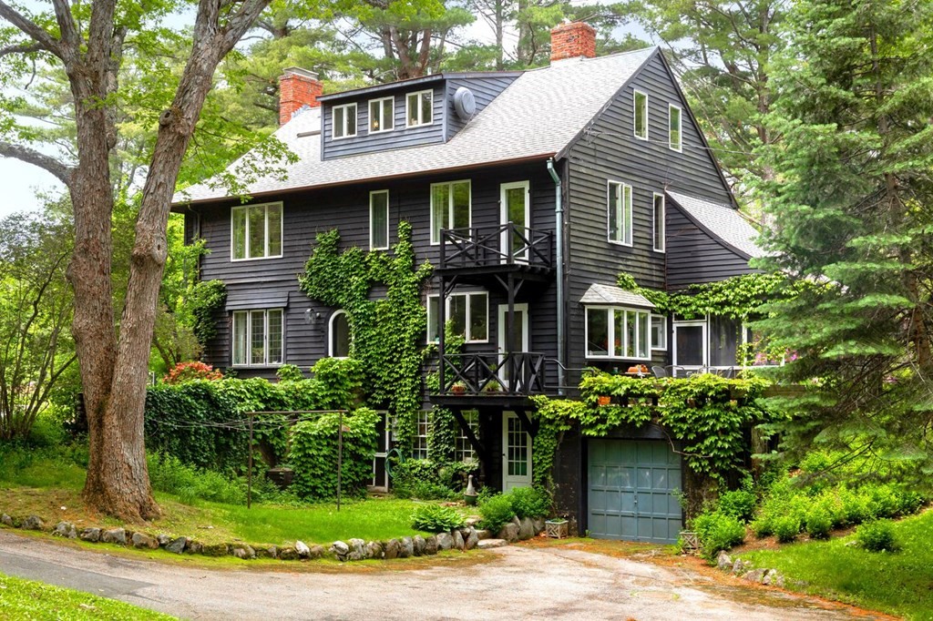 893 Highland Street Hamilton, MA 01982 - Photo 3 of 42 a view of a white house next to a yard with plants and trees