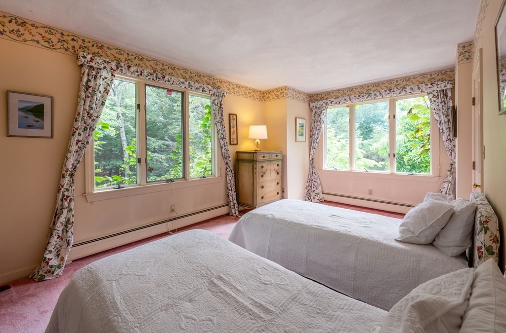 893 Highland Street Hamilton, MA 01982 - Photo 32 of 42 a bedroom with a large bed and a large window