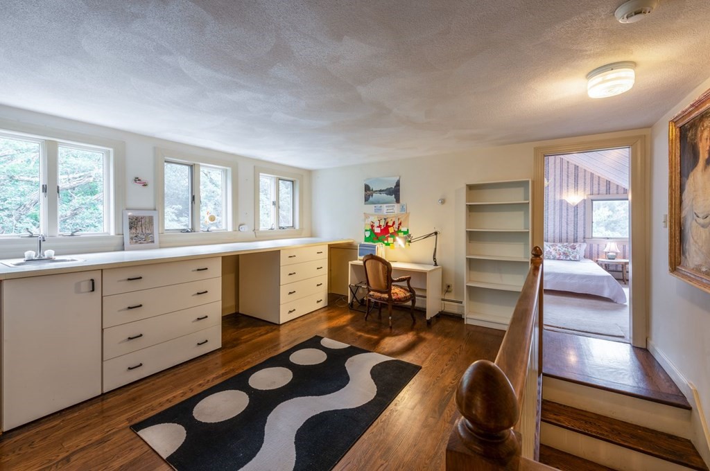 893 Highland Street Hamilton, MA 01982 - Photo 34 of 42 a room with furniture a rug and a window