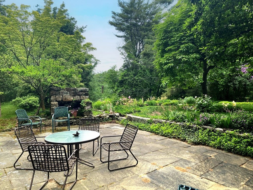 893 Highland Street Hamilton, MA 01982 - Photo 7 of 42 a table and chairs in a garden