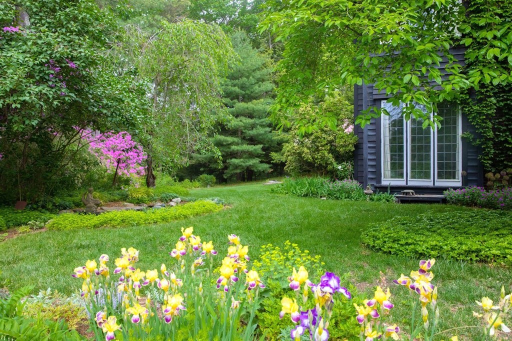 893 Highland Street Hamilton, MA 01982 - Photo 8 of 42 a front view of a house with a yard and fountain