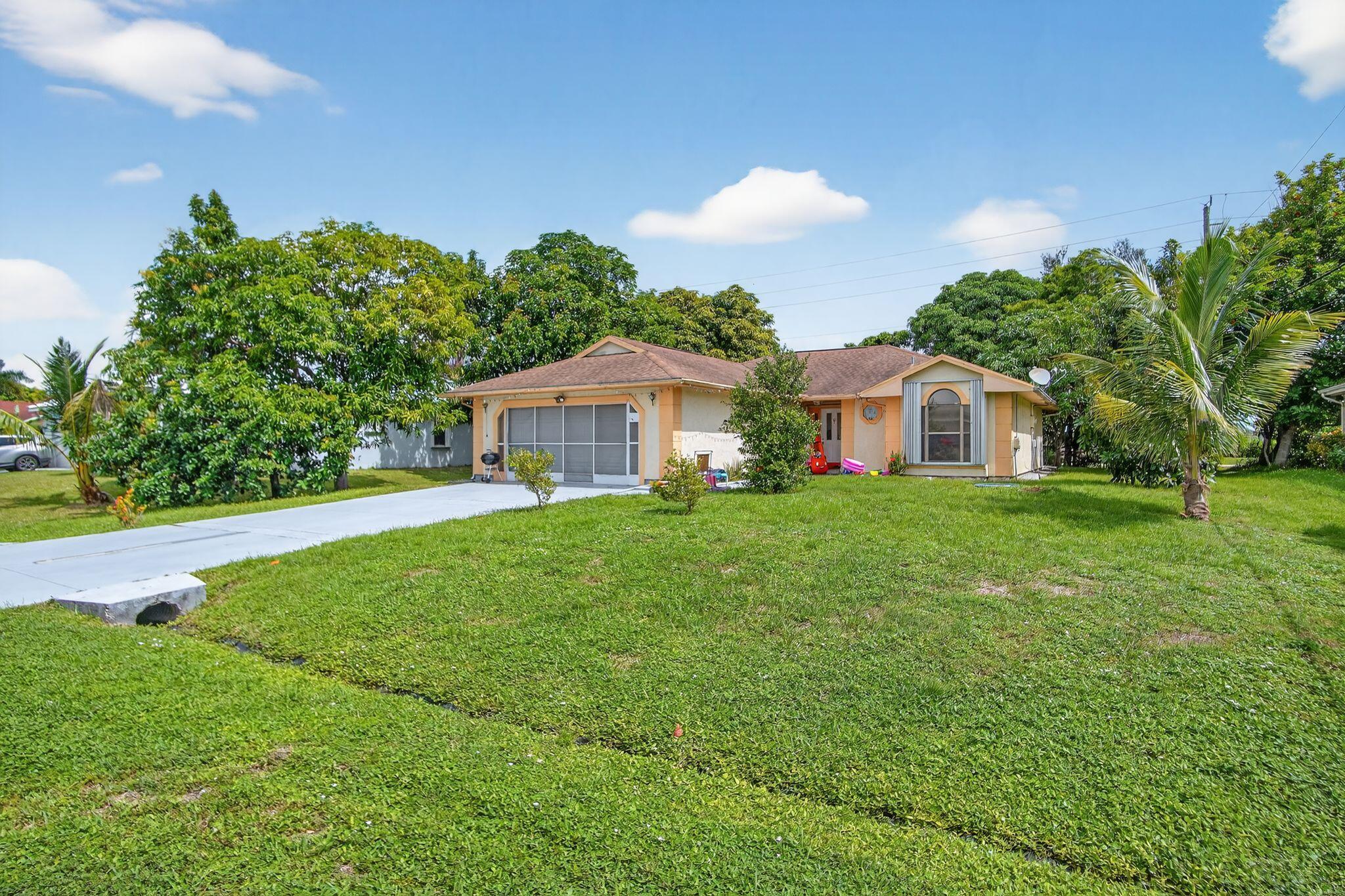 3053 Southeast Wake Road Port St. Lucie, FL 34984 - Photo 11 of 28 a front view of a house with garden