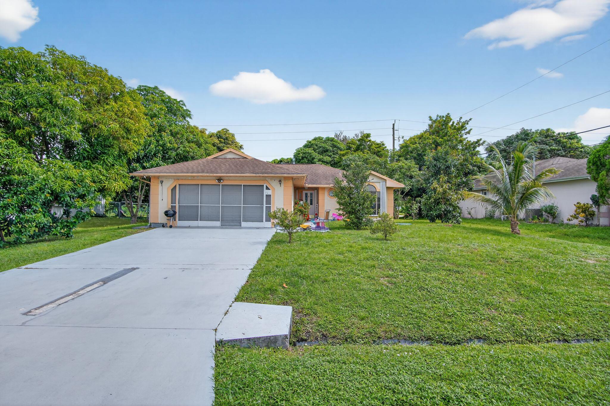 3053 Southeast Wake Road Port St. Lucie, FL 34984 - Photo 13 of 28 a front view of a house with garden