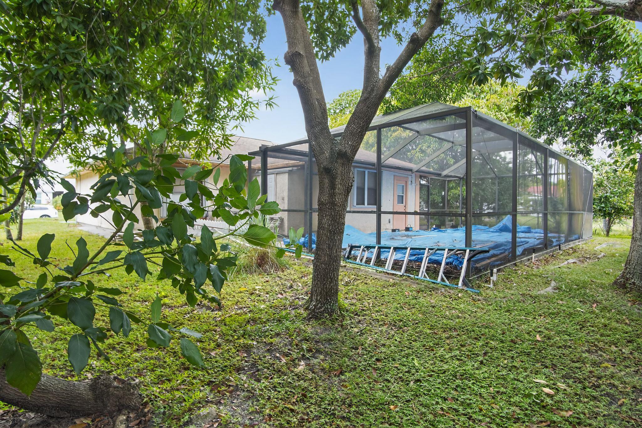 3053 Southeast Wake Road Port St. Lucie, FL 34984 - Photo 15 of 28 a view of a house with backyard and sitting area