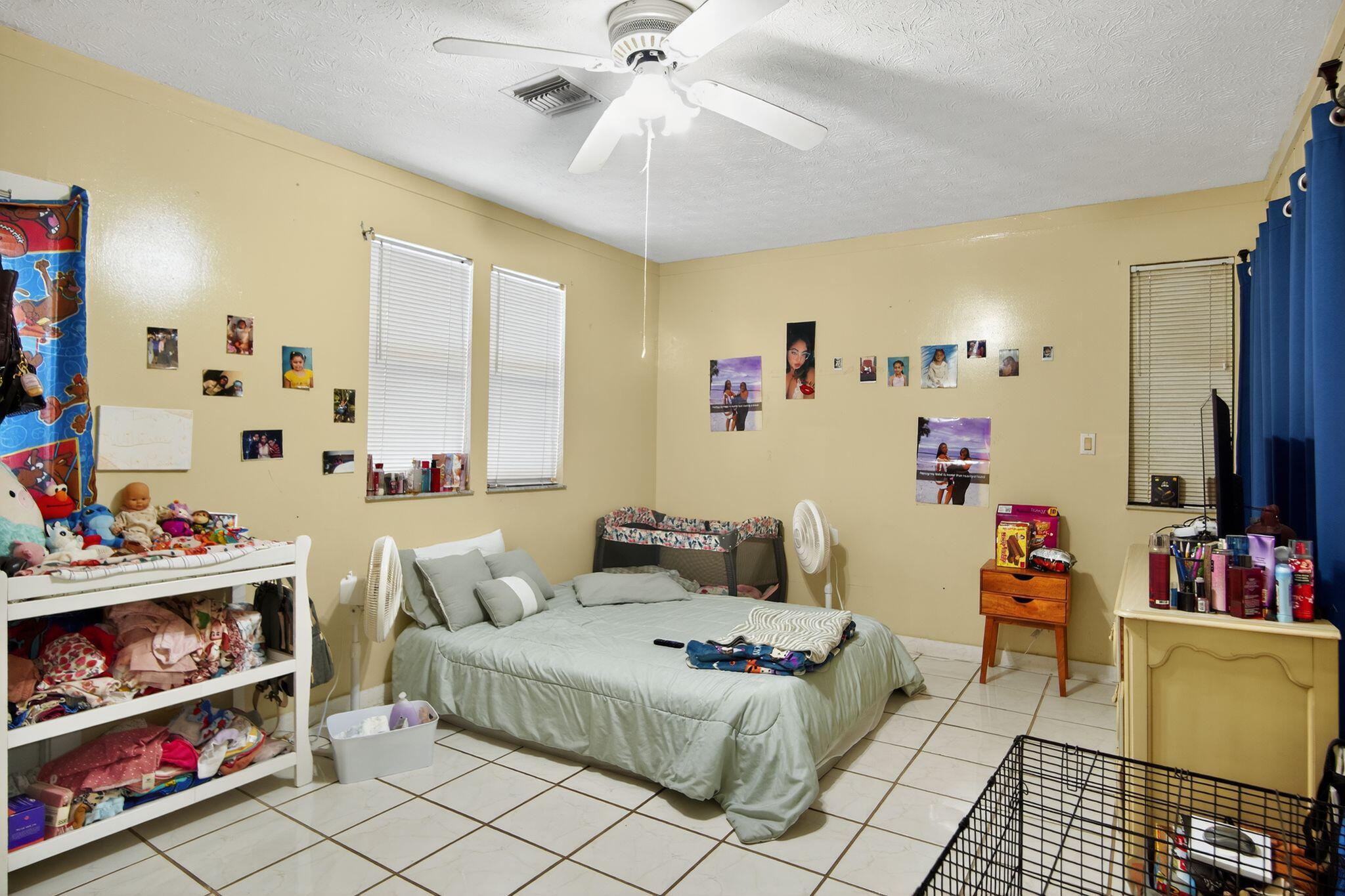 3053 Southeast Wake Road Port St. Lucie, FL 34984 - Photo 2 of 28 a bedroom with furniture and a chandelier fan