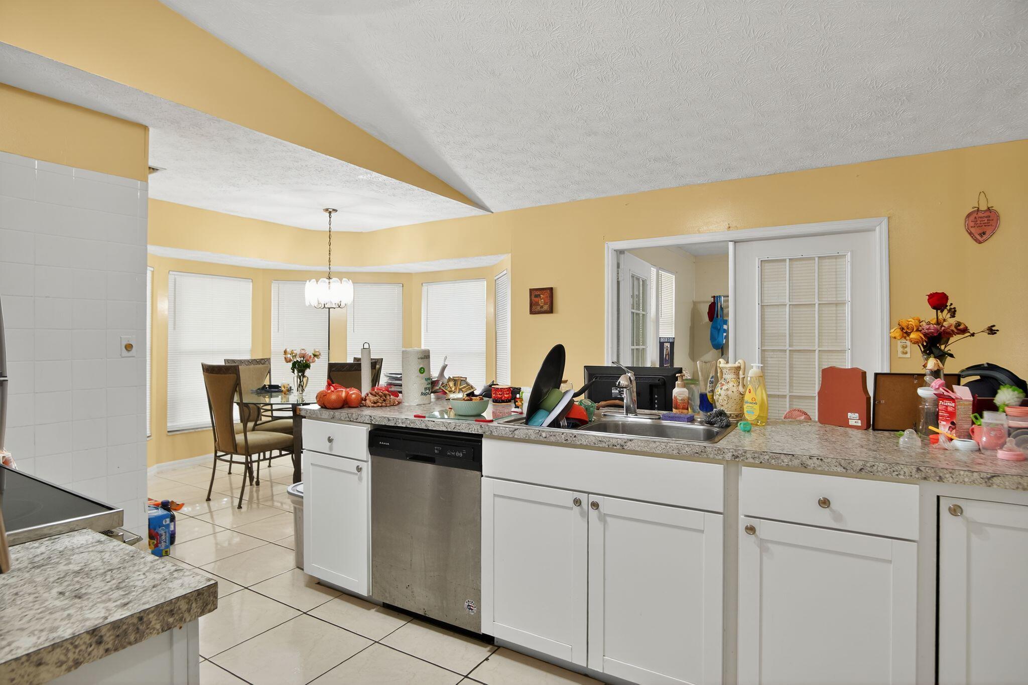3053 Southeast Wake Road Port St. Lucie, FL 34984 - Photo 22 of 28 a kitchen with sink and view of living room