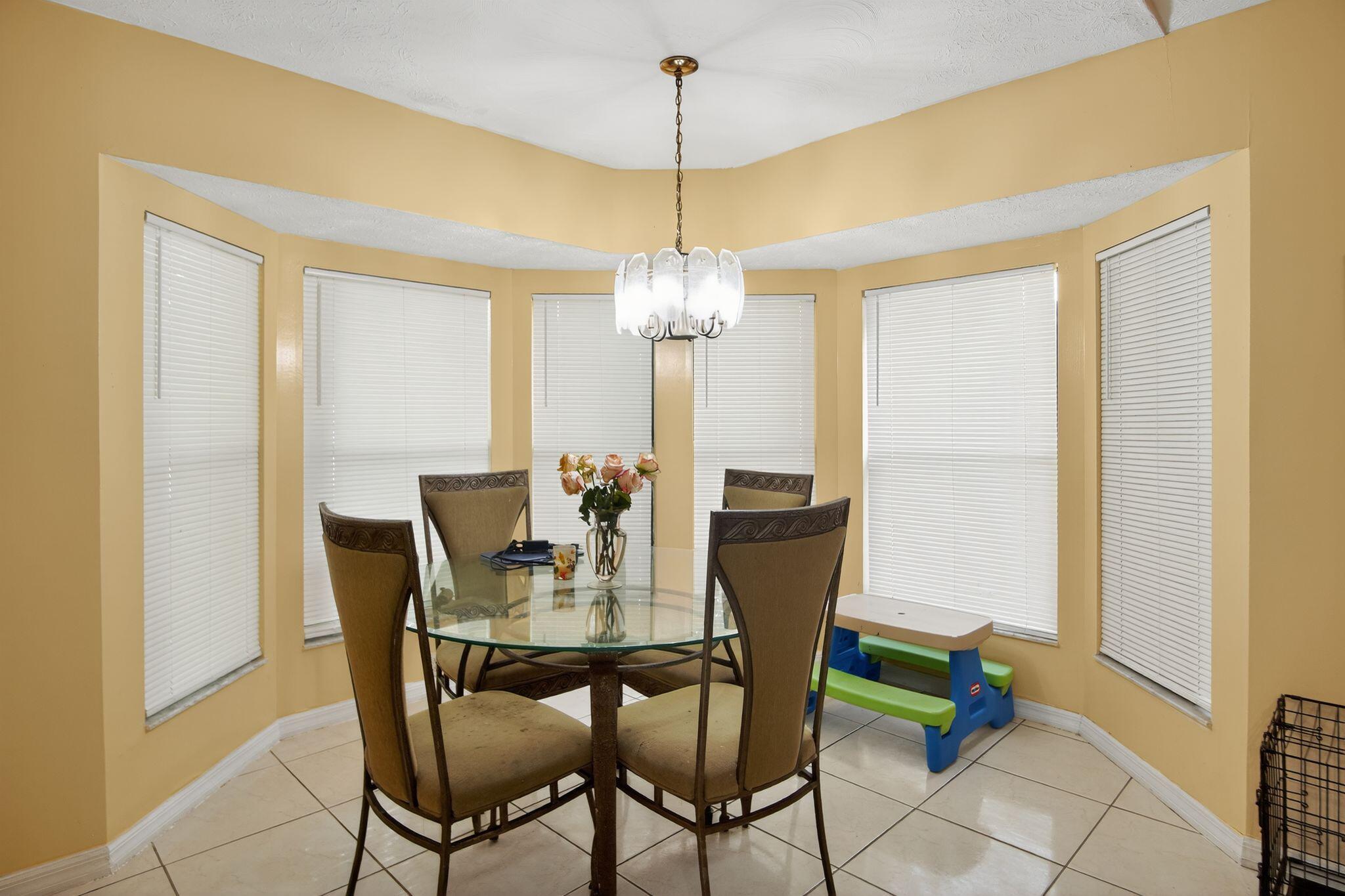 3053 Southeast Wake Road Port St. Lucie, FL 34984 - Photo 26 of 28 a dining room with furniture and window