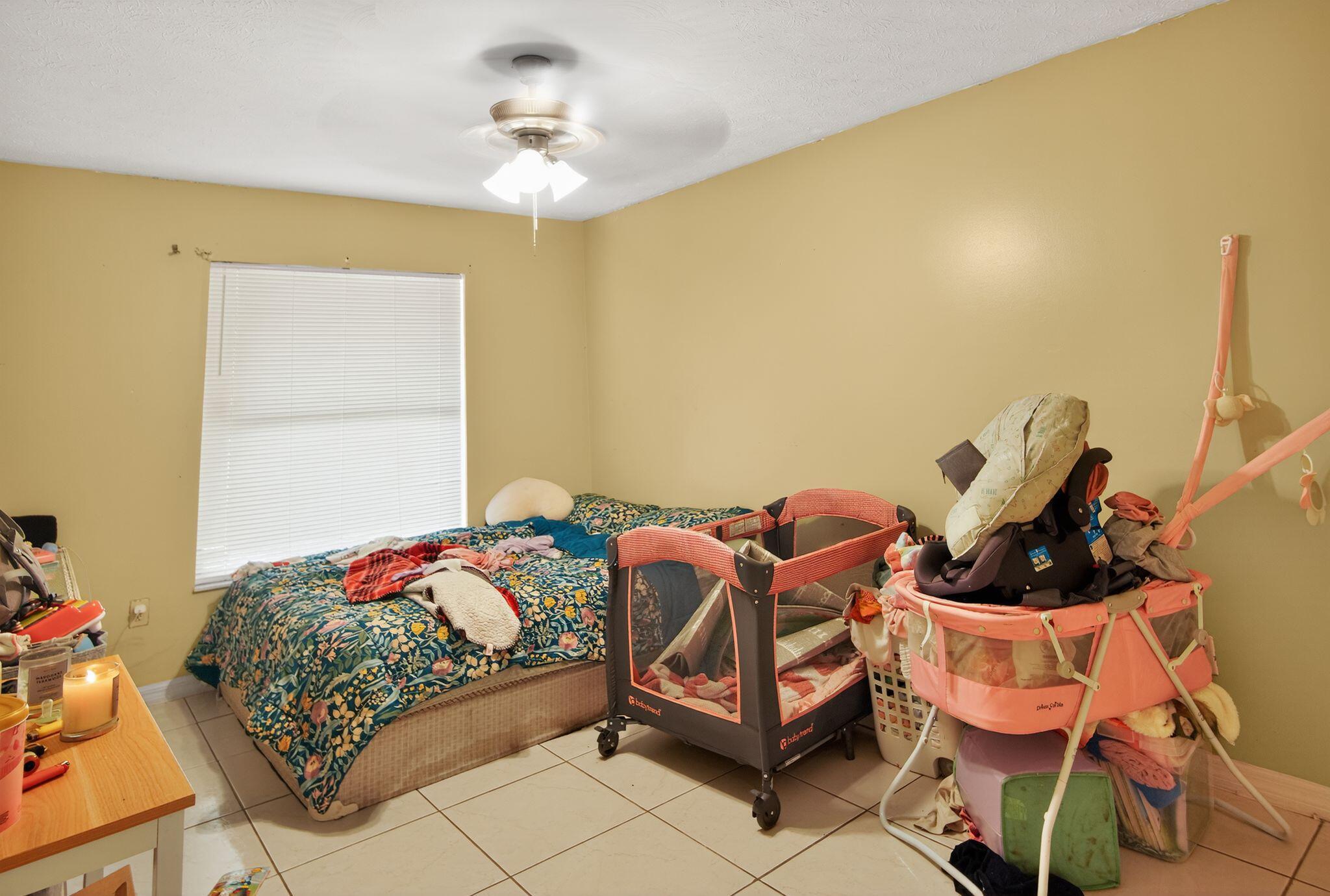 3053 Southeast Wake Road Port St. Lucie, FL 34984 - Photo 28 of 28 a bedroom with a bed and wooden floor