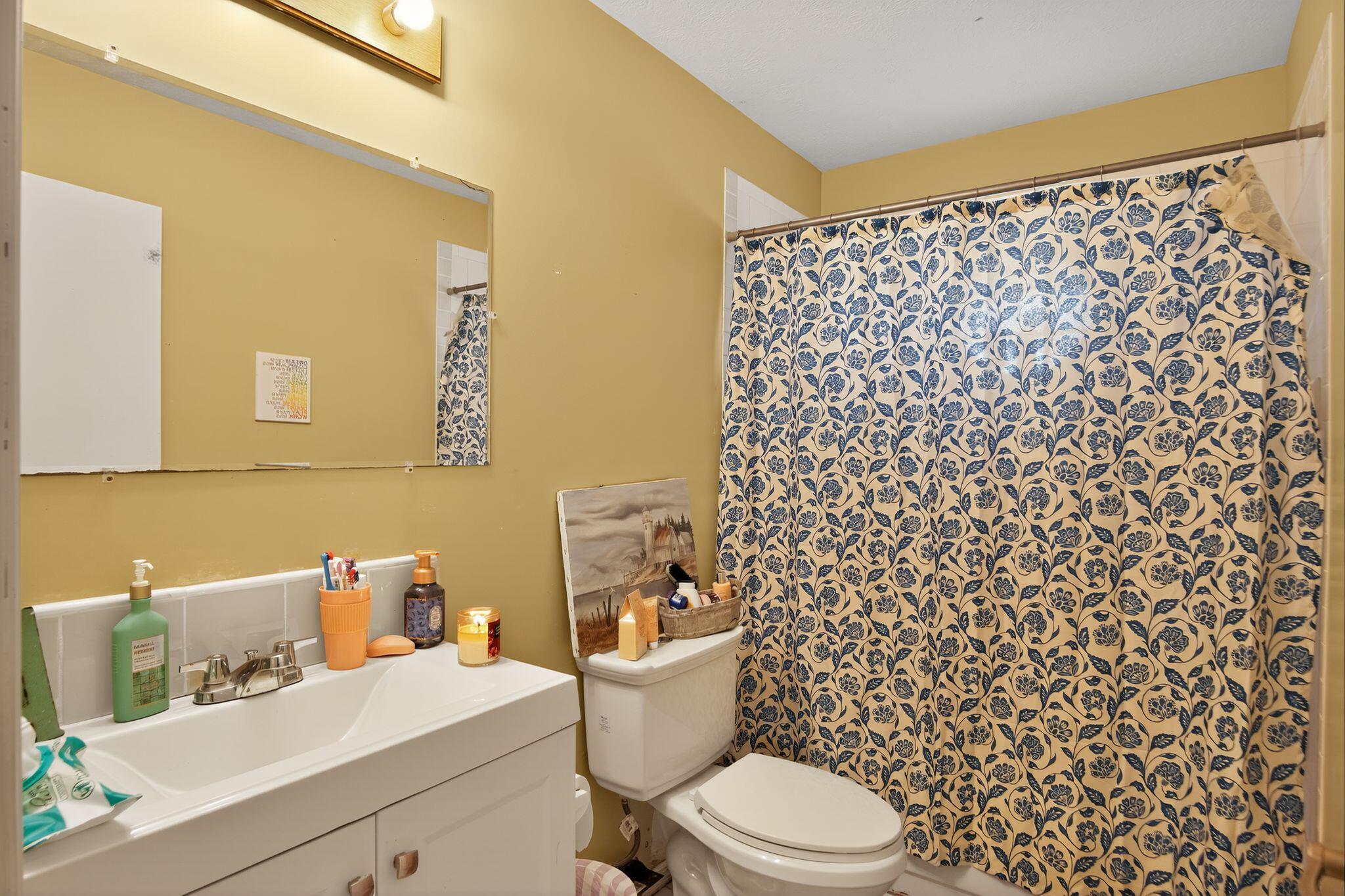 3053 Southeast Wake Road Port St. Lucie, FL 34984 - Photo 9 of 28 a white toilet sitting next to a bathroom sink