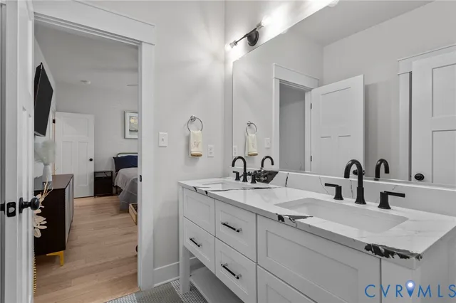 a bathroom with double vanity sinks and a mirror