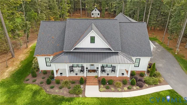 an aerial view of a house with table and chairs
