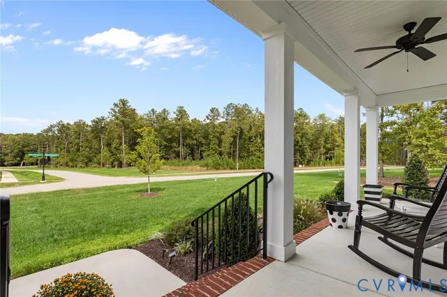 a view of a porch with furniture and a yard