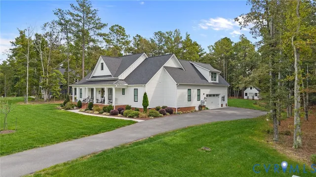 a aerial view of a house with a yard and potted plants