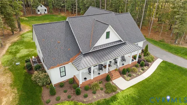 a front view of a house with a yard table and chairs