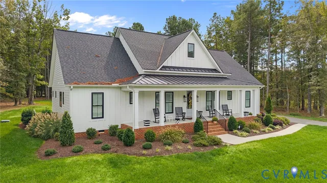 an aerial view of a house with a yard and large tree