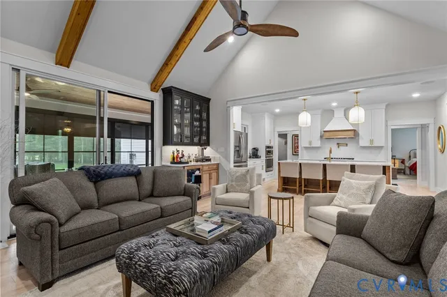 a living room with furniture wooden floor and a large window
