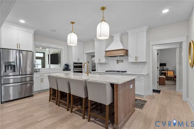a kitchen with a table chairs sink and cabinets