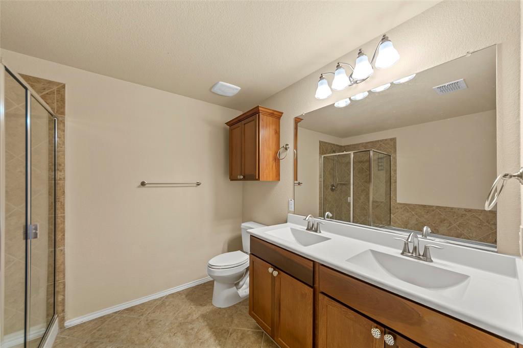 716 Harrison Lane Lavon, TX 75166 - Photo 13 of 40 a bathroom with a toilet sink and mirror