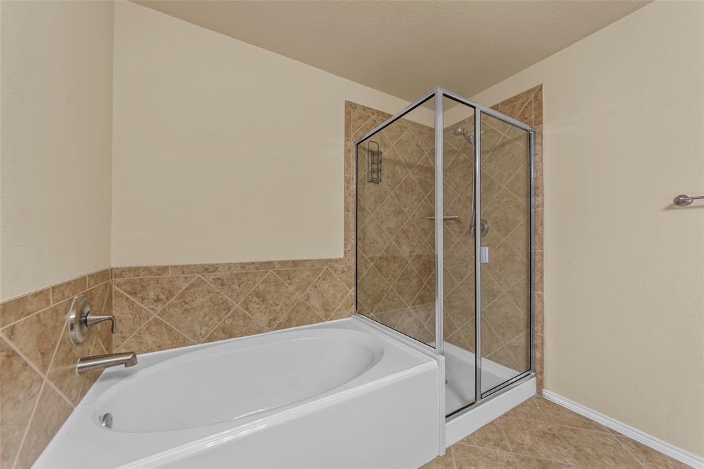 716 Harrison Lane Lavon, TX 75166 - Photo 14 of 40 a bathroom with a bathtub and a shower