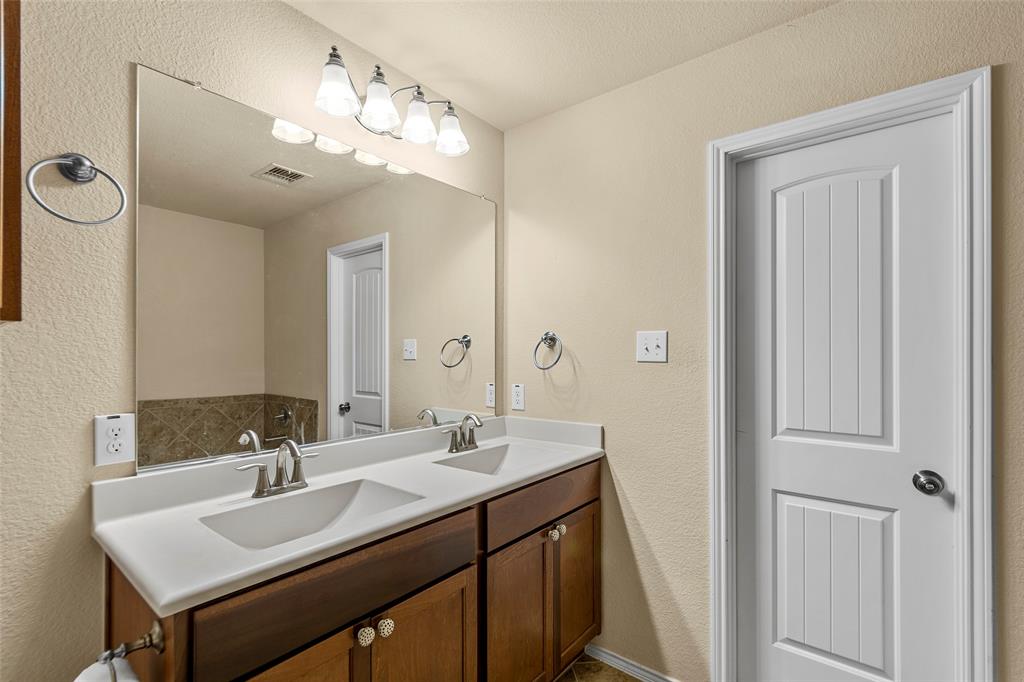 716 Harrison Lane Lavon, TX 75166 - Photo 15 of 40 a bathroom with a sink vanity and a mirror