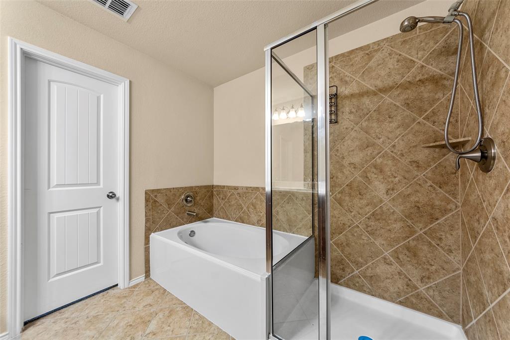 716 Harrison Lane Lavon, TX 75166 - Photo 16 of 40 a bathroom with a bathtub and shower
