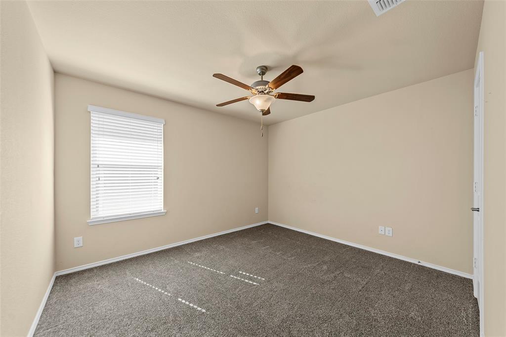 716 Harrison Lane Lavon, TX 75166 - Photo 18 of 40 an empty room with a window and a ceiling fan