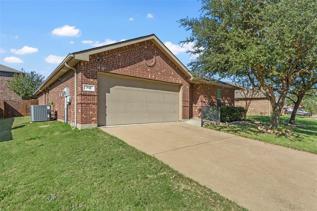 716 Harrison Lane Lavon, TX 75166 - Photo 2 of 40 a front view of a house with a yard and garage