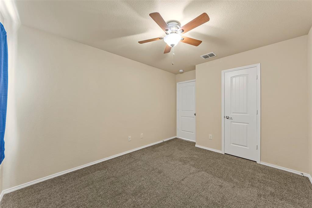716 Harrison Lane Lavon, TX 75166 - Photo 21 of 40 an empty room with a chandelier fan and windows