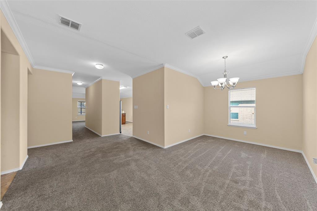 716 Harrison Lane Lavon, TX 75166 - Photo 24 of 40 an empty room with chandelier fan and windows