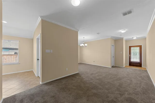 a large kitchen with a stove a refrigerator and a kitchen island
