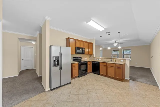 a kitchen with stainless steel appliances granite countertop a sink a stove and a microwave oven
