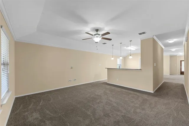 an empty room with fan and a ceiling fan