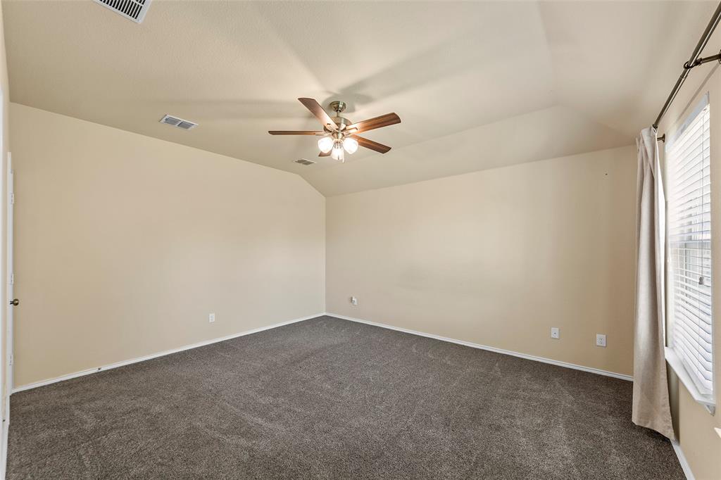 716 Harrison Lane Lavon, TX 75166 - Photo 10 of 40 an empty room with a window and a ceiling fan