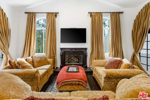 a living room with furniture fireplace and a flat screen tv