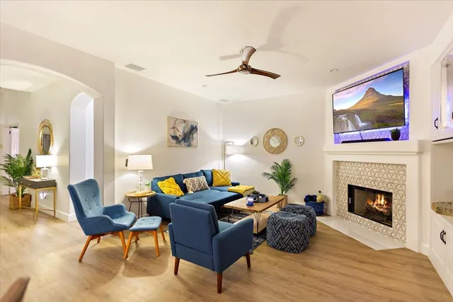 a bedroom with a bed mirror and painting on the wall