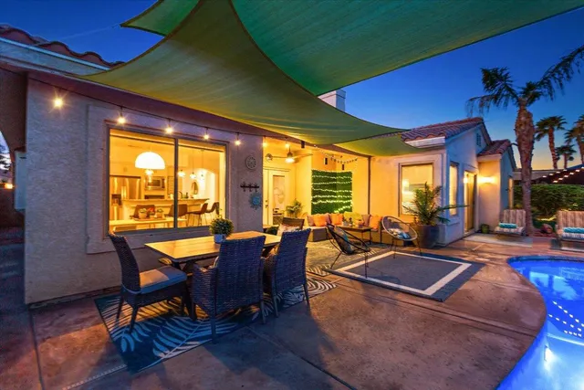 a view of a swimming pool with an outdoor space and seating area