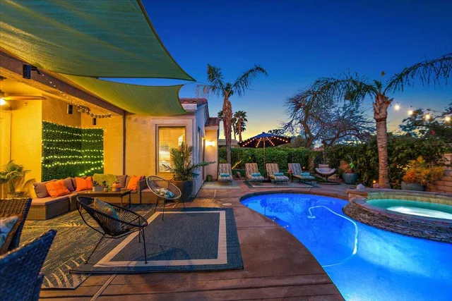 a living room with furniture a flat screen tv and a large window
