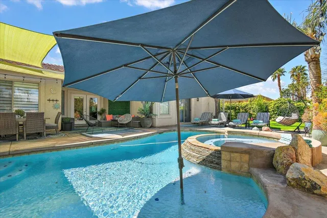 a view of a chairs and table in a backyard