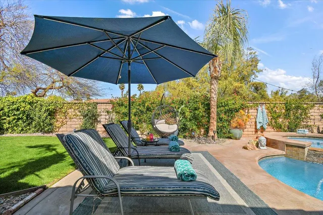 a view of a swimming pool with a patio