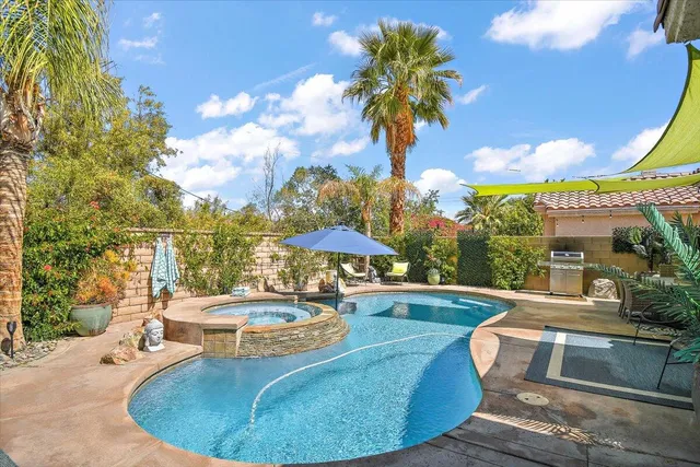 a view of a patio with swimming pool table and chairs