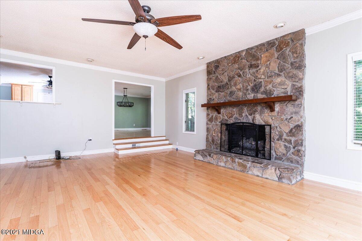 455 Lite-N-Tie Road Gray, GA 31032 - Photo 12 of 47 a view of empty room with fireplace and wooden floor