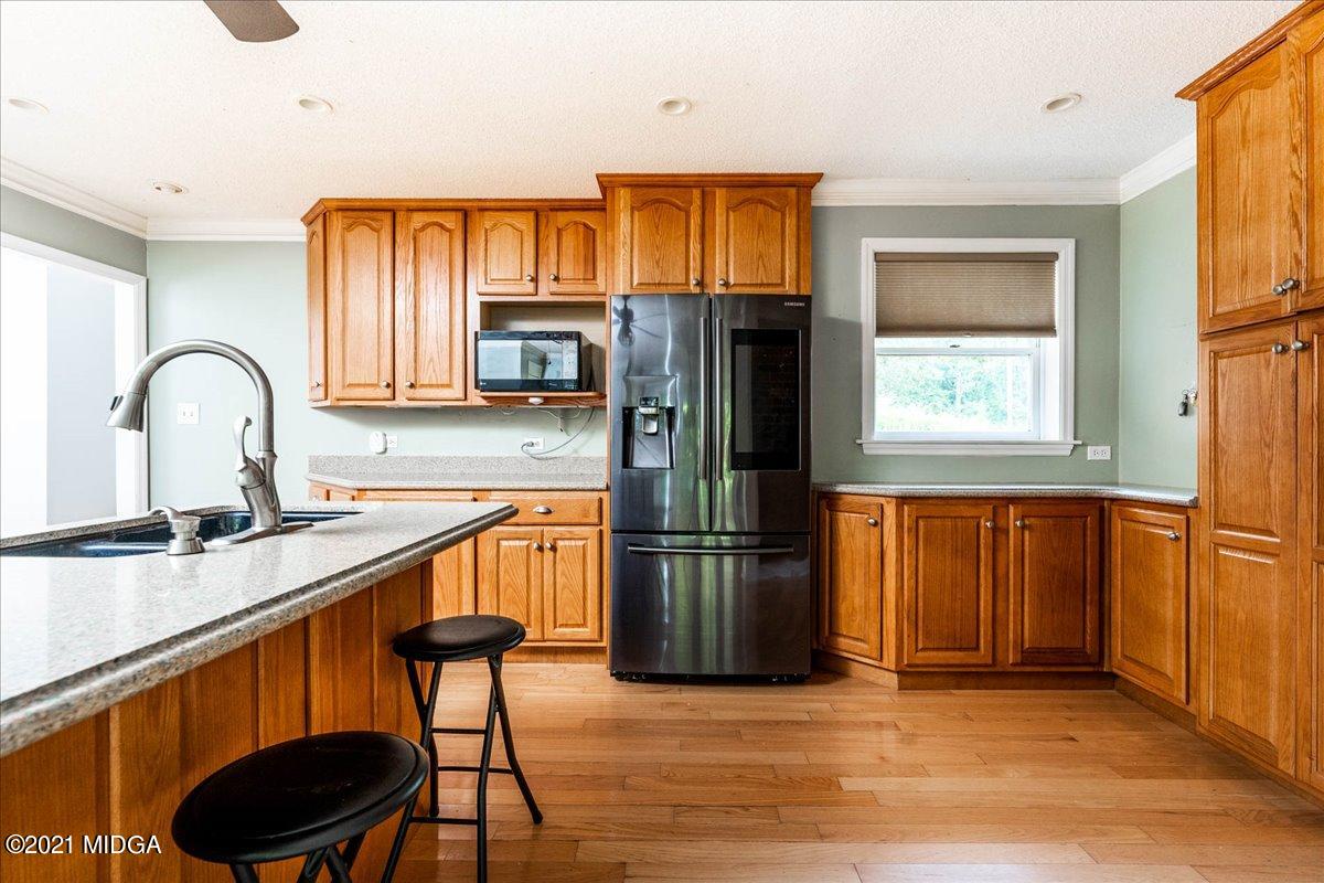 455 Lite-N-Tie Road Gray, GA 31032 - Photo 15 of 47 a kitchen with stainless steel appliances granite countertop a refrigerator and a stove top oven