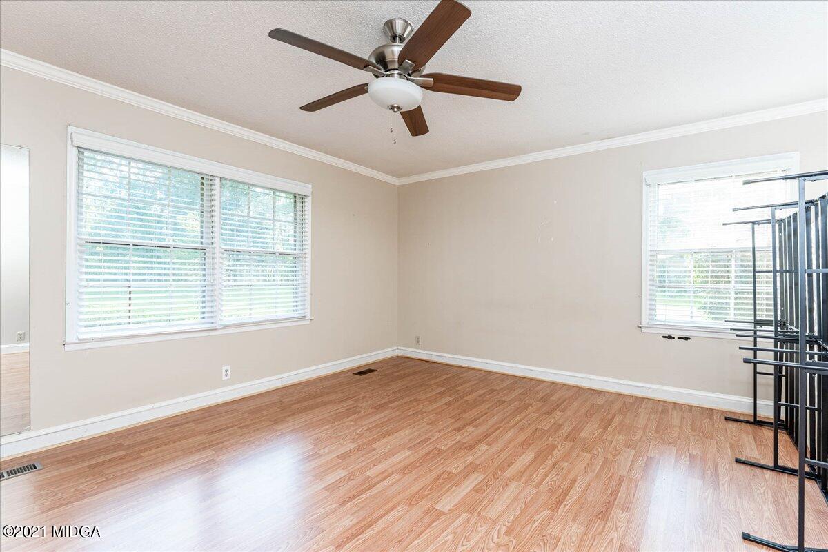 455 Lite-N-Tie Road Gray, GA 31032 - Photo 18 of 47 a view of empty room with wooden floor and fan