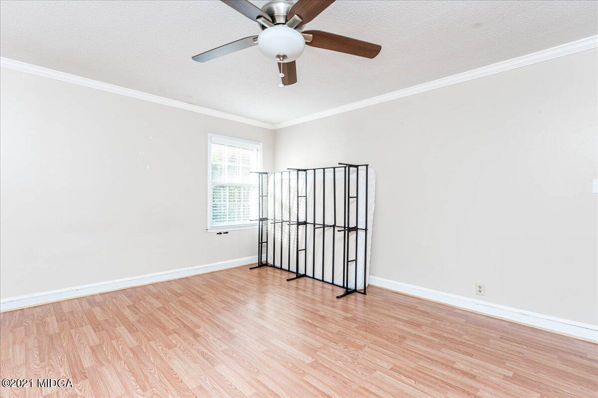 455 Lite-N-Tie Road Gray, GA 31032 - Photo 19 of 47 an empty room with wooden floor fan and windows