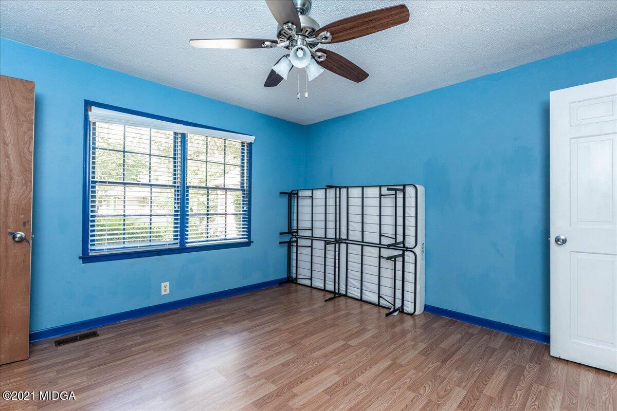 455 Lite-N-Tie Road Gray, GA 31032 - Photo 23 of 47 an empty room with wooden floor and windows